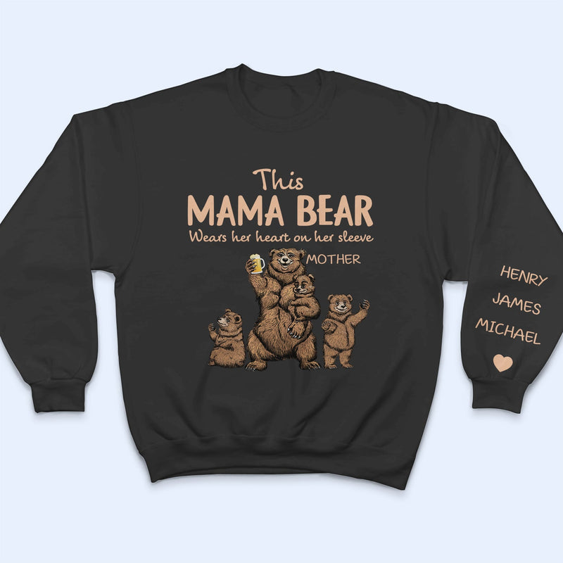 This Mama Bear Wears Her Heart - Gift For Mom, Nana - Personalized Unisex Sweatshirt With Design On Sleeve