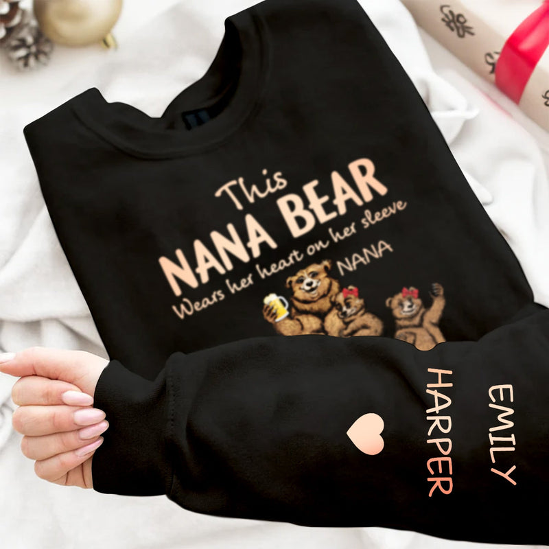 This Mama Bear Wears Her Heart - Gift For Mom, Nana - Personalized Unisex Sweatshirt With Design On Sleeve